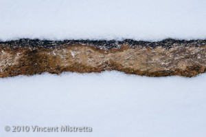Stone Wall Covered in Snow
